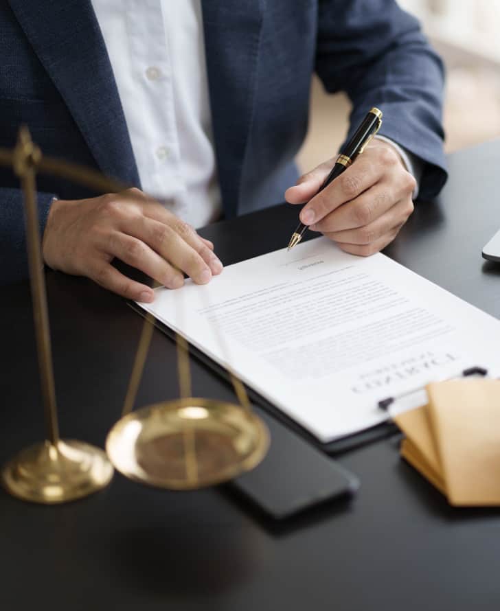 An image of a lawyer about to sign a contract.